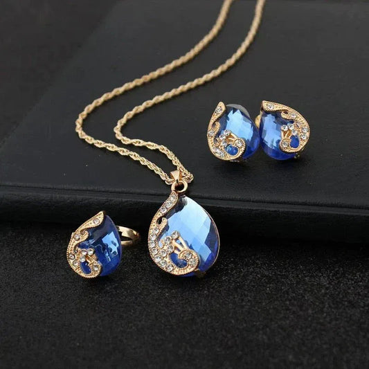 Blue Crystal Necklace + Earring Set in Blue Crystal in Gold