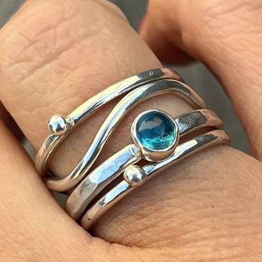 Layered ring with blue crystal