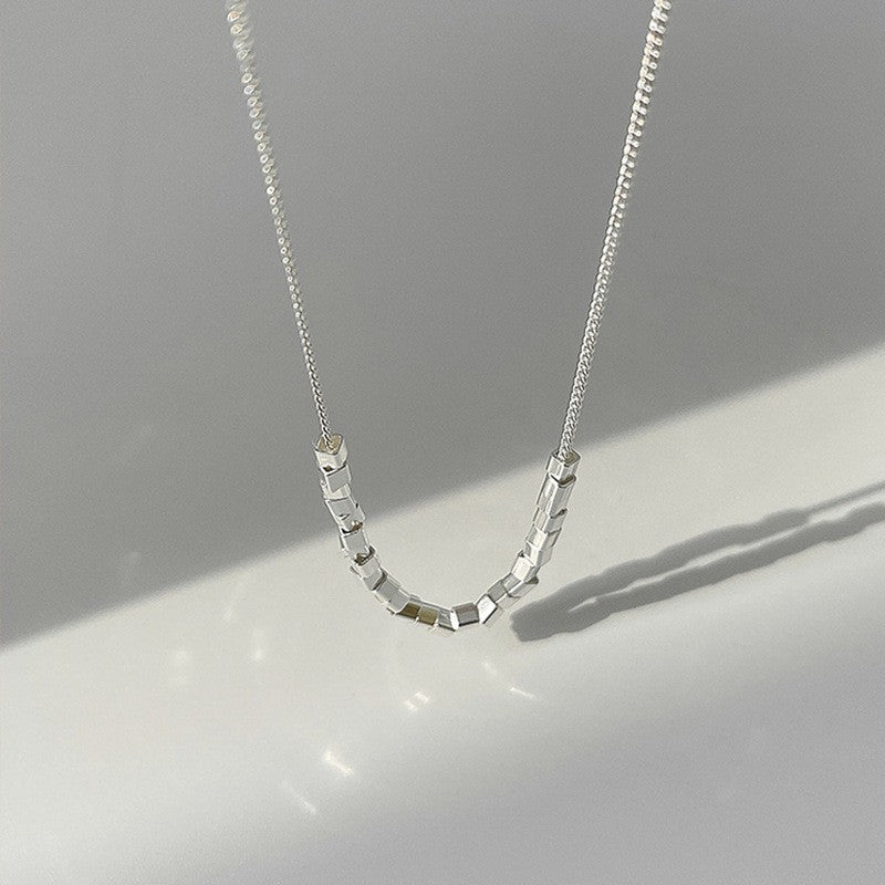 Modern pearl-inspired necklace with a sleek chain design