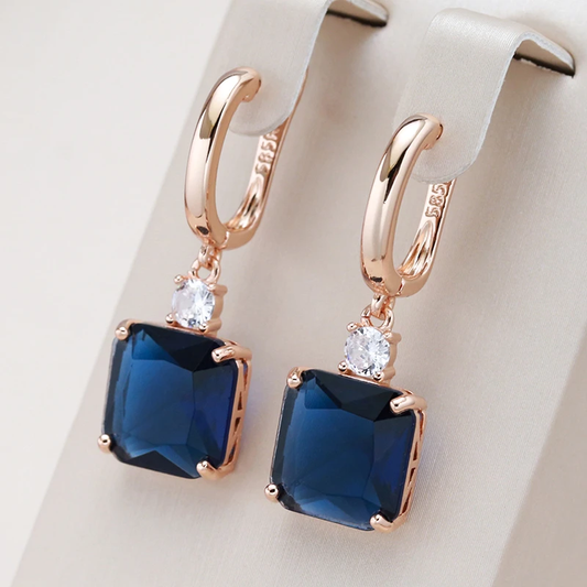 Elegant earrings with dark blue crystal in gold